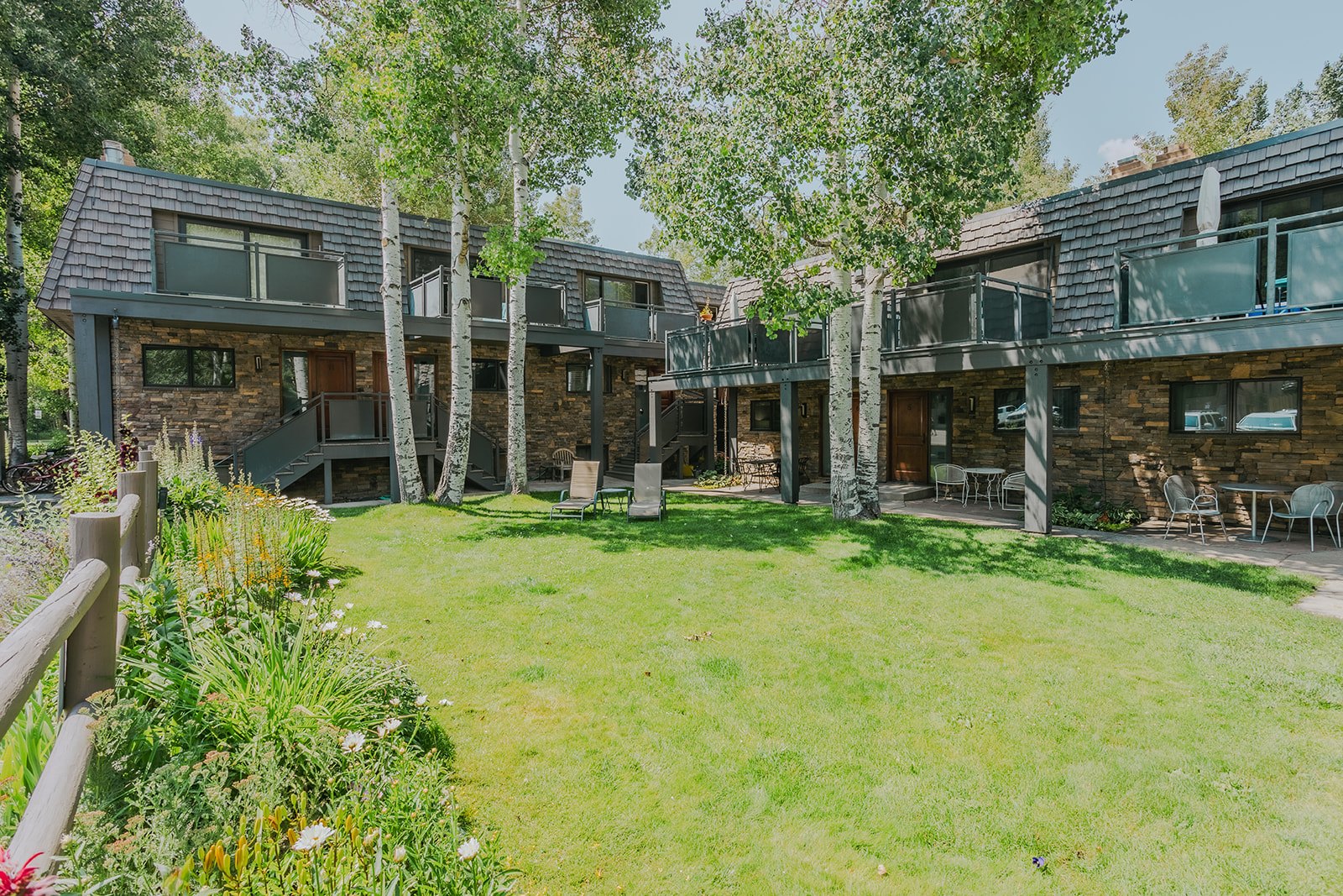 Aspen condominium buildings around a landscaped shared courtyard
