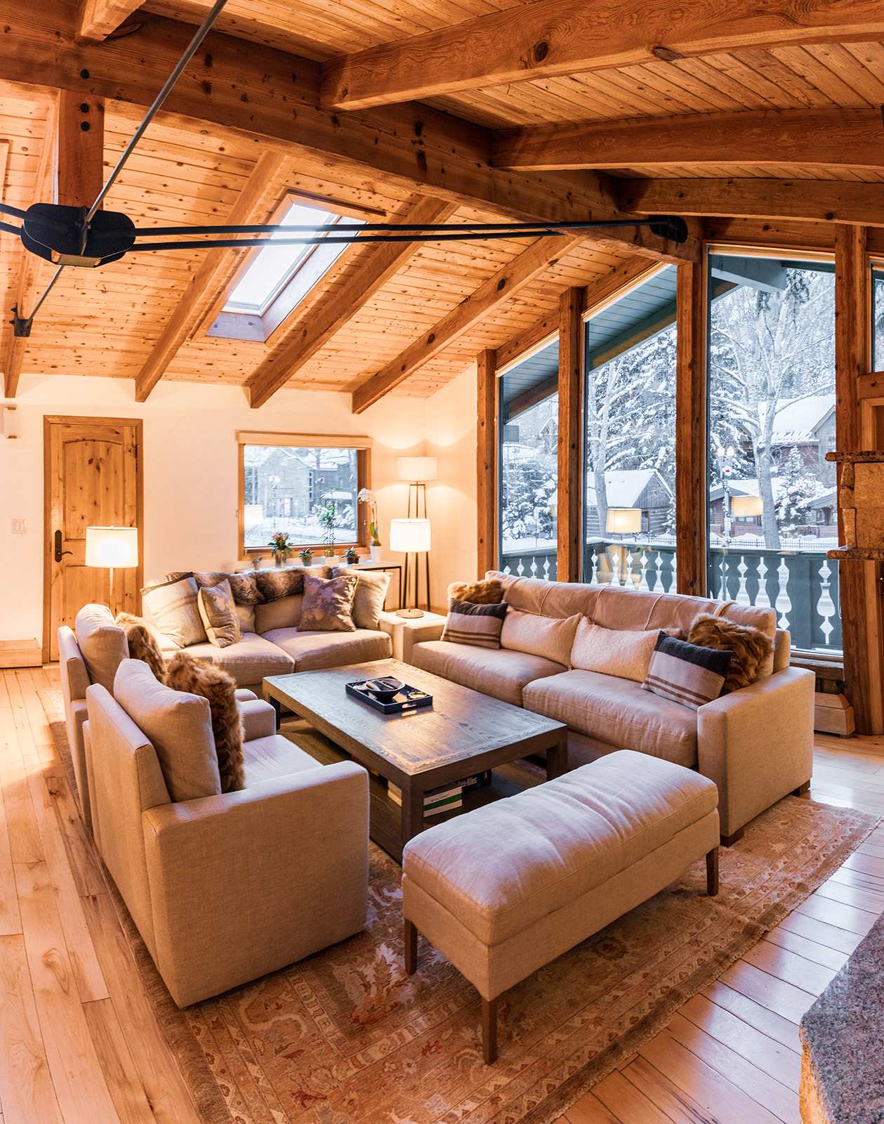 Ullr living room with timber ceilings and winter views